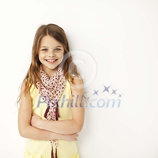 Smiling girl standing by the wall Smiling girl standing by the wall