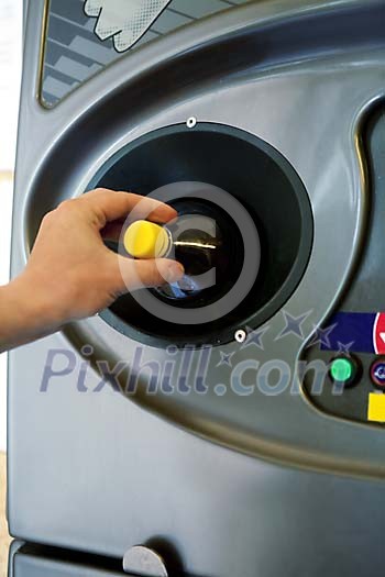 Plastic bottle being placed in the machine Plastic bottle being placed in the machine