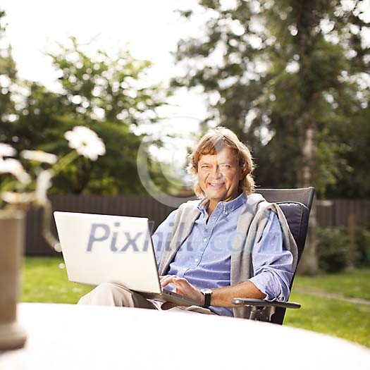 Man sitting outside with laptop Man sitting outside with laptop
