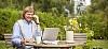 Man doing office work in the garden