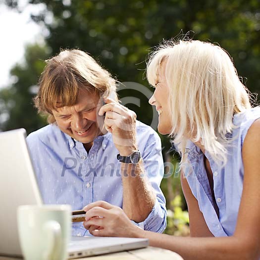 Couple sitting outside with laptop Couple sitting outside with laptop