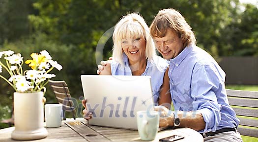 Couple sitting in the garden on a sunny day Couple sitting in the garden on a sunny day
