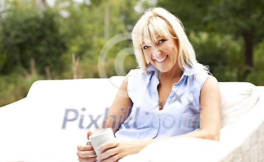 Smiling woman sitting on the terrace Smiling woman sitting on the terrace