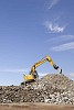 Excavator working on the rubble hill