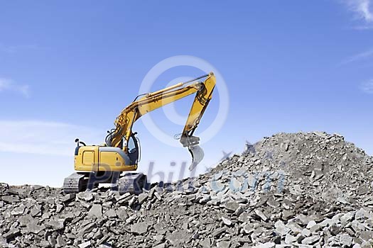 Excavator on the rubble hill Excavator on the rubble hill