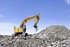 Excavator on the rubble hill