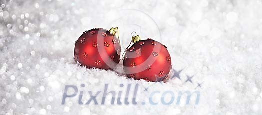 Red christmas balls on the snow Red christmas balls on the snow