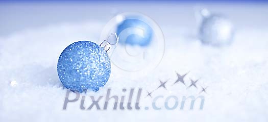 Blue christmas balls on the snow Blue christmas balls on the snow