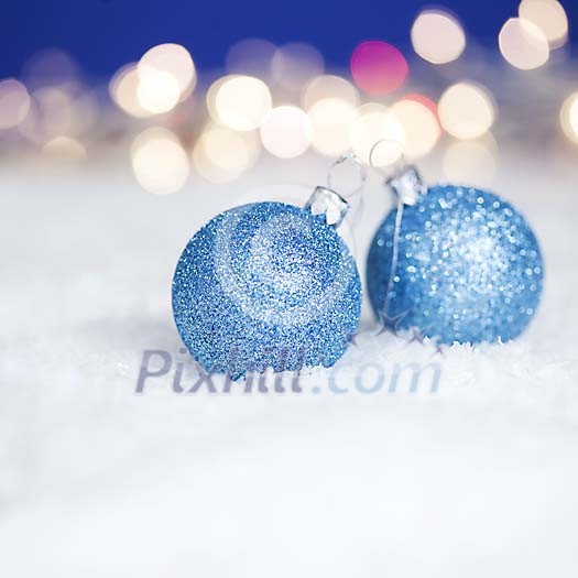 Blue christmas balls on the snow Blue christmas balls on the snow