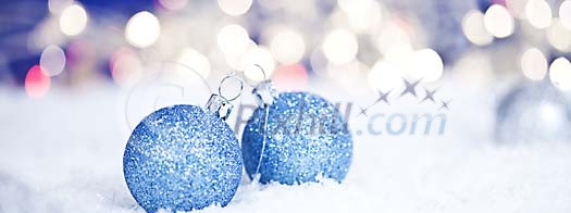 Blue christmas balls on the snow Blue christmas balls on the snow