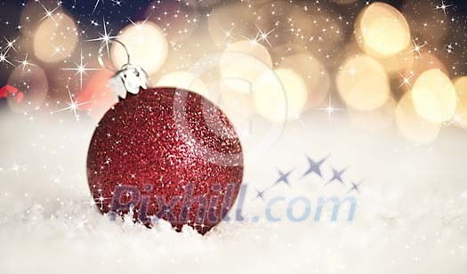 Red christmas ball on the snow Red christmas ball on the snow