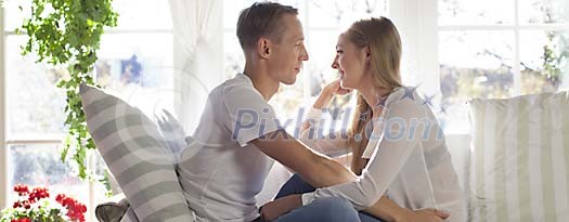 Couple sitting close on the sofa Couple sitting close on the sofa