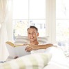 Man reading a book on the sofa