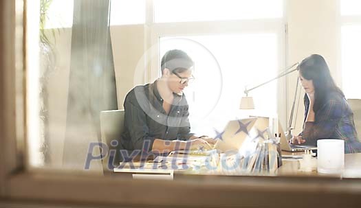 Mand and a woman sitting in the office Mand and a woman sitting in the office