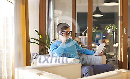 Man sitting in the office, talking to a phone Man sitting in the office, talking to a phone