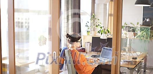 Woman working by the desk Woman working by the desk