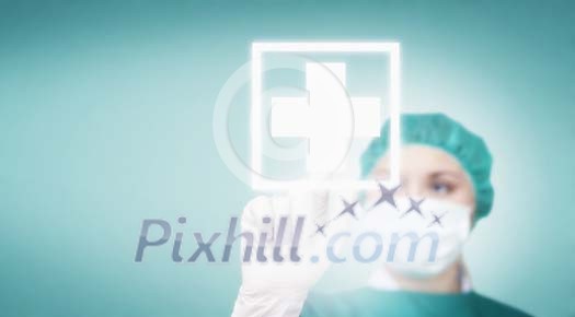 Female surgeon touching a white cross on a virtual screen Female surgeon touching a white cross on a virtual screen