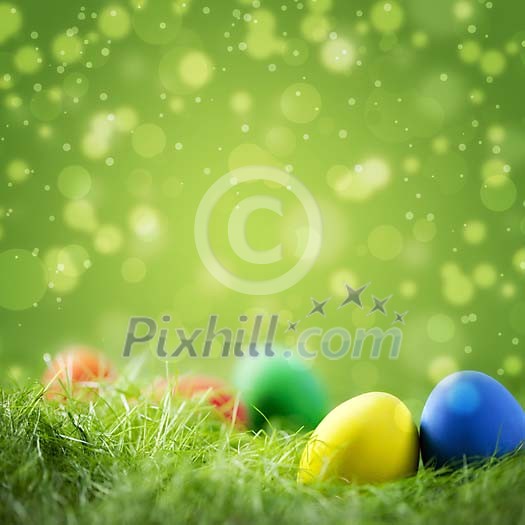 Colorful easter eggs on grass against festive green background with copyspace Colorful easter eggs on grass against festive green background with copyspace