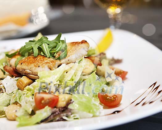 Portion of chicken steak and green salad