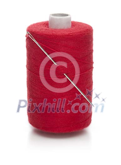 Isolated red sewing thread with a needle Isolated red sewing thread with a needle