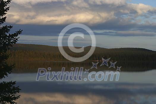 View over lake Tjautjasjaur in midnight sun. View over lake Tjautjasjaur in midnight sun.