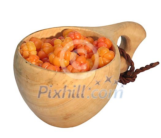 Golden berries from the forests of Lapland in a wooden cup Golden berries from the forests of Lapland in a wooden cup