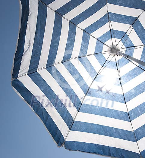 Blue parasol shading the sun Blue parasol shading the sun