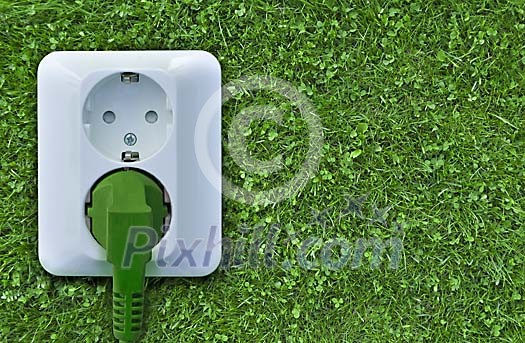 Electrical outlet on green grass Electrical outlet on green grass