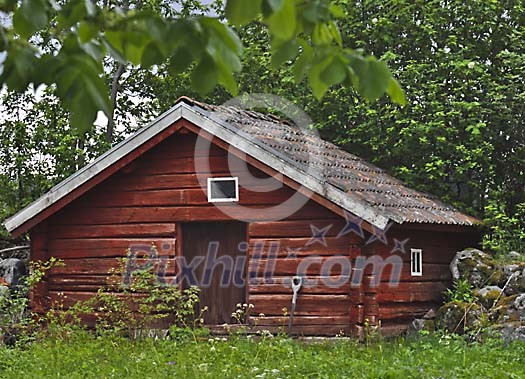 Red log cabin on green yard Red log cabin on green yard
