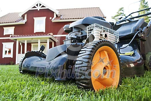 Lawn mower in front of house Lawn mower in front of house