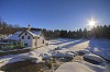 House next to a river on a sunny winter day