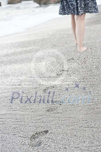 Woman walking alone on the beach