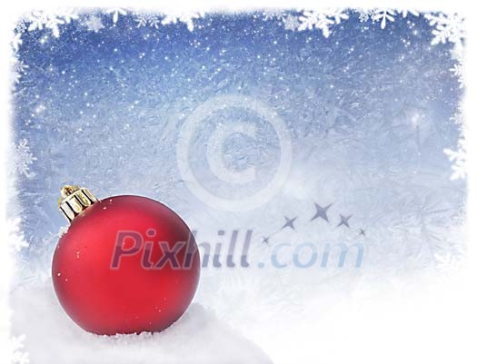 A red christmas ball lying on snow with a snowy background A red christmas ball lying on snow with a snowy background