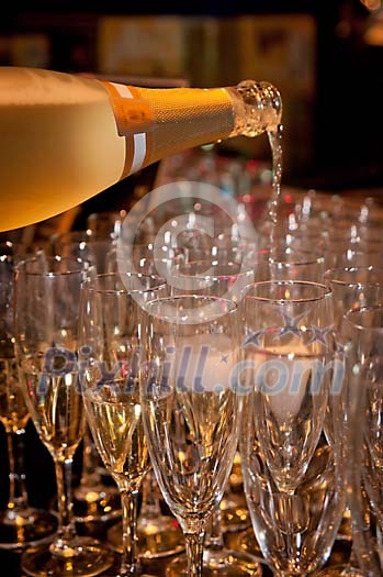 Champagne being poured to the glasses Champagne being poured to the glasses