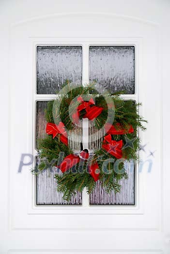 Christmas wreath on a white door Christmas wreath on a white door