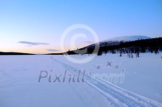 Tracks on arctic lake at sunset Tracks on arctic lake at sunset
