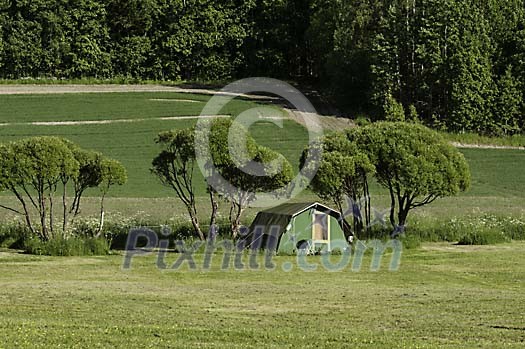 Green tent on a green field Green tent on a green field