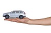 Isolated hand holding a toy car
