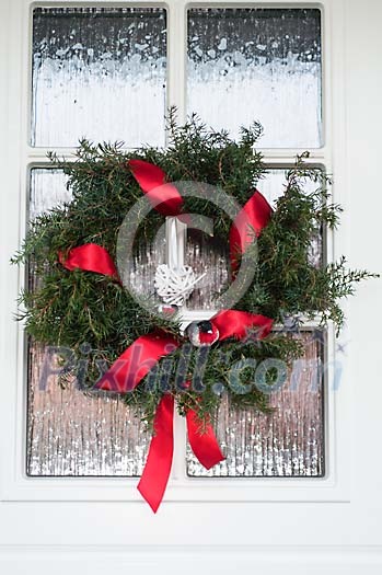 Christmas wreath hanging on the front door Christmas wreath hanging on the front door