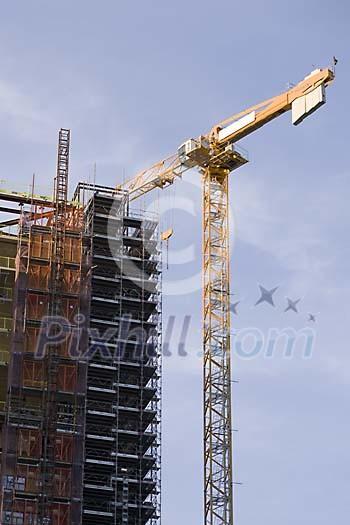 Tall crane next to a house Tall crane next to a house