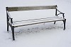 Lonely bench left in wintery park