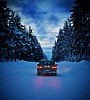 Car on winter road in the forest