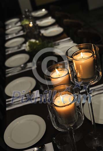 Dinner table with plates and utensils Dinner table with plates and utensils