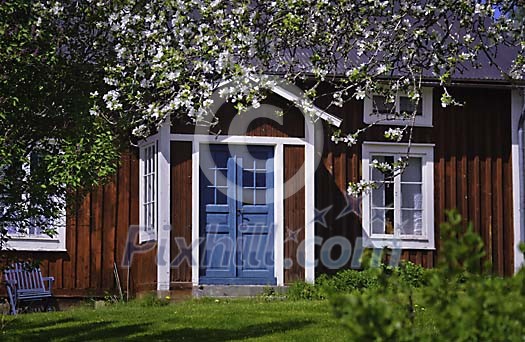 Idyllic red house with blue front door Idyllic red house with blue front door