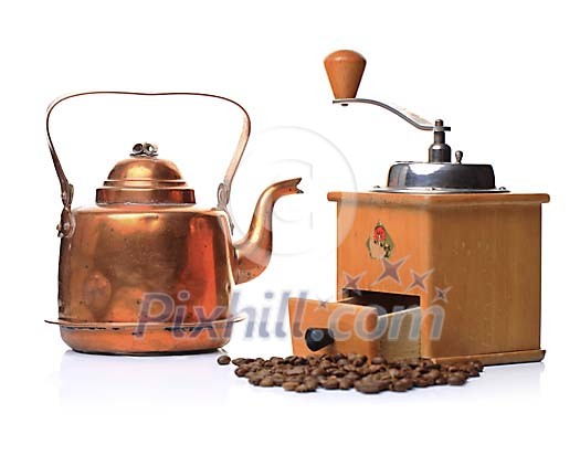 Old coffee grinder and a kettle with coffee beans Old coffee grinder and a kettle with coffee beans