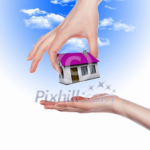 Human hand against blue sky background and house Human hand against blue sky background and house