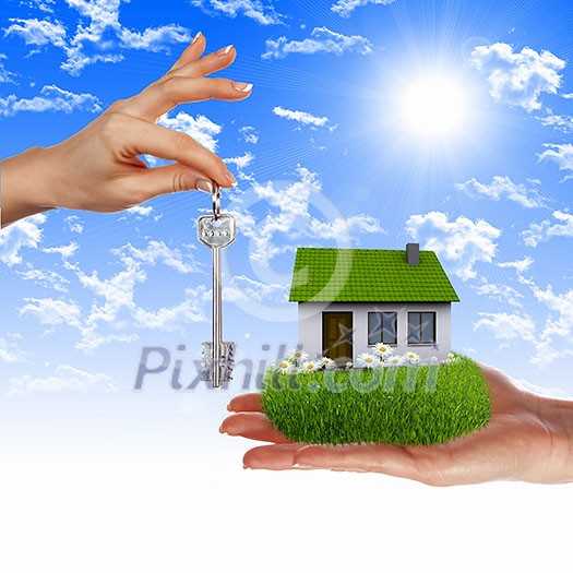 Human hand against blue sky background and house Human hand against blue sky background and house