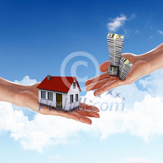 Human hand against blue sky background and house Human hand against blue sky background and house