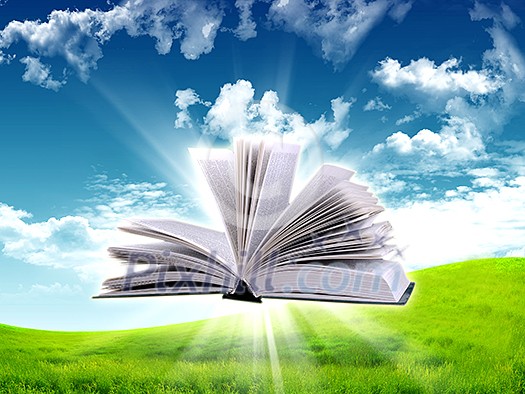 book in the air against green panoramic nature landscape book in the air against green panoramic nature landscape