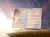 book in the air against green panoramic nature landscape